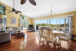 Wall of sliding glass doors open to the balcony next to the Pinellas trail.