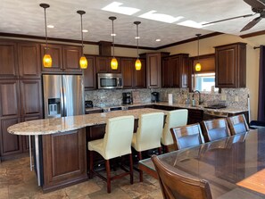 first floor open concept kitchen, eating area and living room