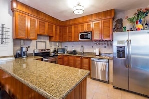 A fully equipped kitchen has everything you might need to prepare a meal, including basic pantry items