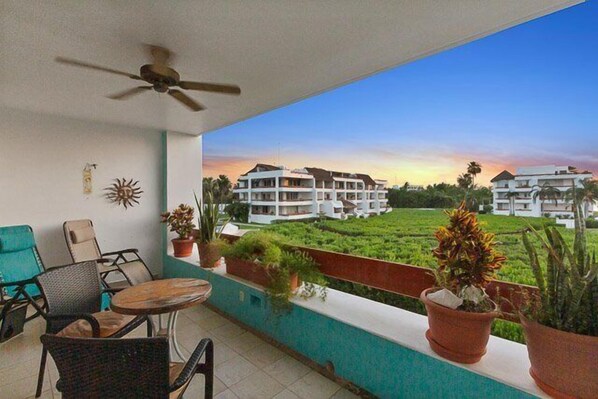 Terrace with lounger, small table and seats, and expansive ocean views