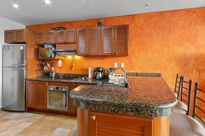 Kitchen with breakfast bar, a dishwasher, and stove and oven
