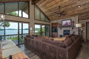 Open floor plan combining living/ dining/kitchen with TV, Roku and fireplace.