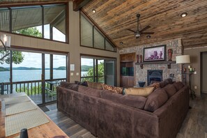 Open floor plan combining living/ dining/kitchen with TV, BluRay and fireplace.