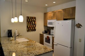 Kitchen with granite countertops, dishwasher and faucet updated in 2023.