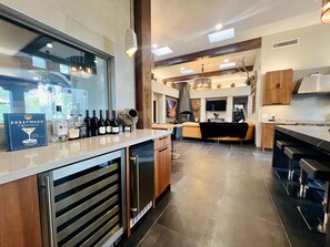 Wet bar w/ wine fridge & ice maker. Easy access from kitchen & Man cave.