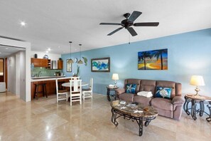 Living room with l-shaped couch, flat screen cable TV, DVD, and WiFi