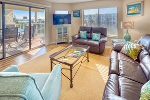 Living Room - Spacious living room with open floor plan and connected balcony featuring a direct view of the ocean.