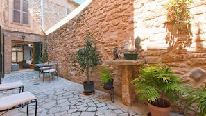 Outdoor dining area at patio with table, chairs and hammocks