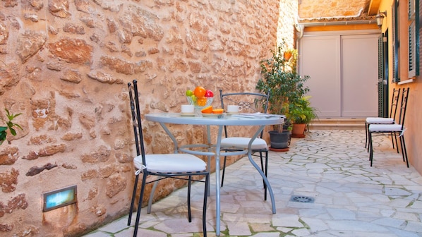 Outdoor dining area at patio with table, chairs