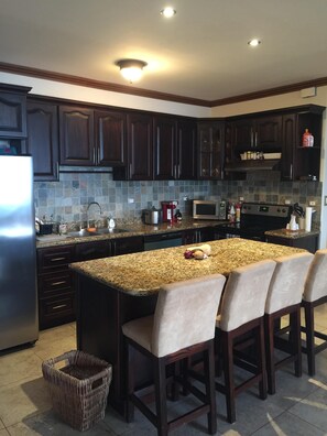 The kitchen has granite countertops and stainless steel appliances. 