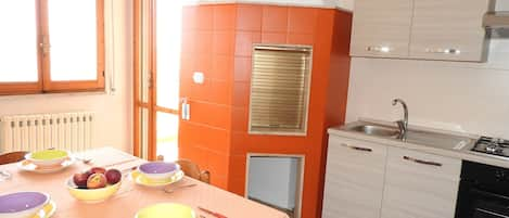 Orange kitchen with traditional oven  