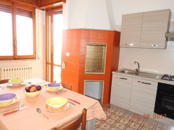 Orange kitchen with traditional oven  