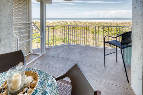 Patio - Oceanfront patio features a table with seating for four and an electric grill for outdoor barbequing. Perfect spot to relax and unwind!