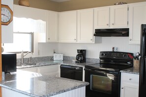 Fully stocked with all the pots, pans, dishes and
utensils for meal preparation.