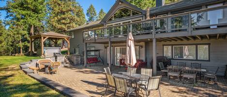 Incredible full length paver patio with BBQ and dining tables