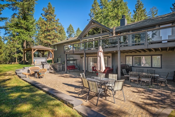 Incredible full length paver patio with BBQ and dining tables