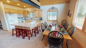 The kitchen provides lots of seating for your family to enjoy a meal around the table.