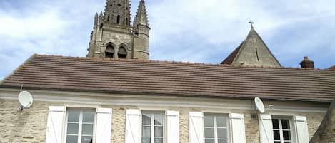 Maison en plein centre du village face à une église 