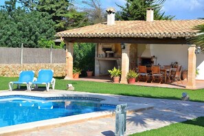 The villa has a pool and grill