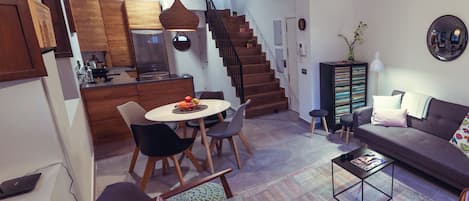 The living room has many windows that can be closed with wooden shutters