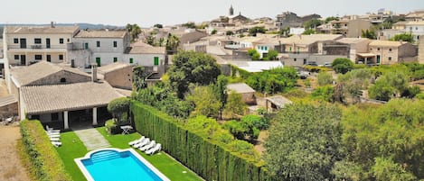 Views of the swimming pool of the villa Tofollubi with the village