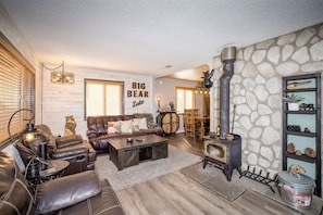 Nice leather couches with laminate floors and cozy log fireplace