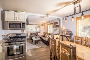 Open stainless steel sparkling kitchen with granite counters.