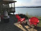 Small firepit overlooking ocean.  Adirondack chairs