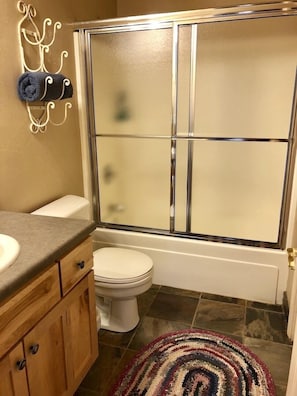 Full size bathroom with Tub/Shower enclosure.