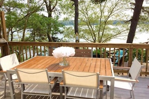 Enjoy your meals on the waterfront Trex deck with charcoal Weber Grill