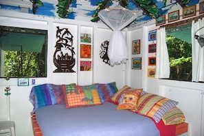 Interior features decorative paintings, metal work & comfortable bed.