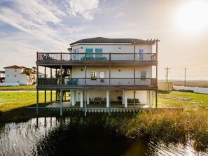 Enjoy fishing or crabbing steps outside of the house!