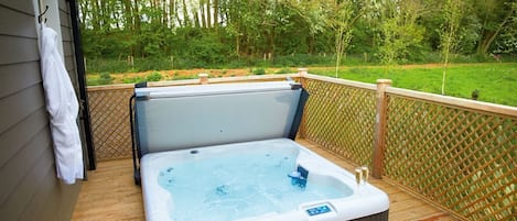 Decked area with garden furniture and hot tub