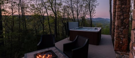 Back deck with incredible mountain views. Fire table with swivel/rocking chairs, along with hot tub (railing has been added as of May 2018).