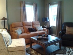 Living room,sofa with three recliners and leather reclining/swivel chair