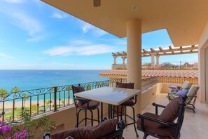 Livingroom terrace looks out over pool, Bay and ocean