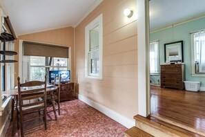 Mid-century add on makes space for a living/dining area and small kitchen to the right, notice the few steps up into the bedroom