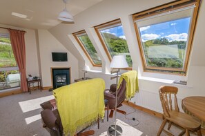 The upstairs living area in Barn looking over the nearby hillside