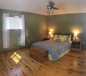 The spacious master bedroom in the large cottage.