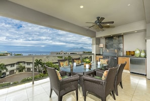 Upper lanai with ocean views, outdoor grill, dining for six and extra seating