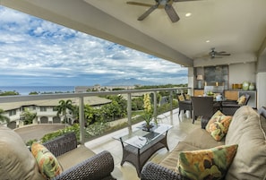 Upper lanai with ocean views, outdoor grill, dining for six and extra seating