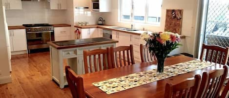 The open plan kitchen / dining area is perfect for preparing home meals.