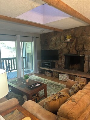 Living room with fireplace and deck