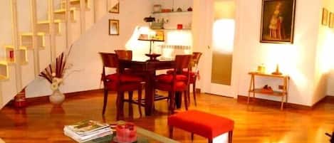 Spacious and comfortable living room with sofa bed, AC, Tv and dining table.