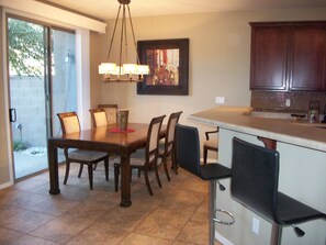 View of adjacent dining for 6, + 2 at the counter. Patio thru the patio door. 