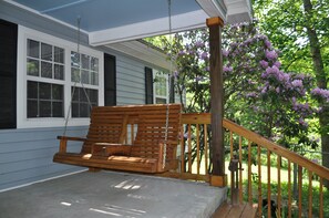 Enjoy the porch swing in the shade of the rhododendron.