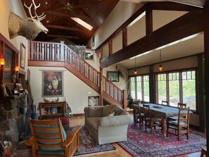 Living room with dining area & wood burning fireplace - stairs to Loft Bedroom 