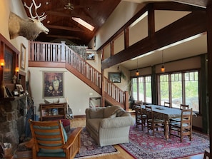 Living room with dining area & wood burning fireplace - stairs to Loft Bedroom 