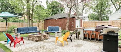 Fenced backyard with hot tub, firepit and grill