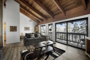 Living area to dining area with a wall of windows